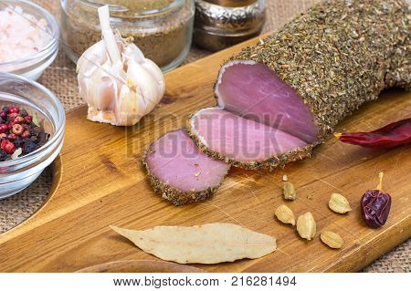 Homemade salted ham, dried herbs and spices. Studio Photo