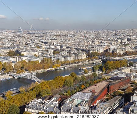 Cityscape of Paris City. Aerial panoramic view of Paris roofs and Seine river as seen from Eiffel Tower in autumn time