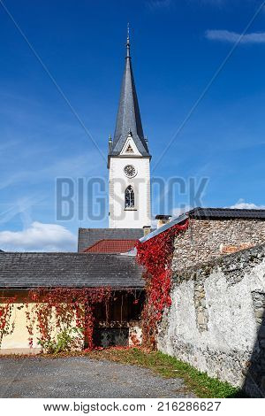Historical center of Gmuend in the fall. Gothic parish church. Gmuend in Kaernten, district of Spittal an der Drau, federal state of Carinthia, Austria