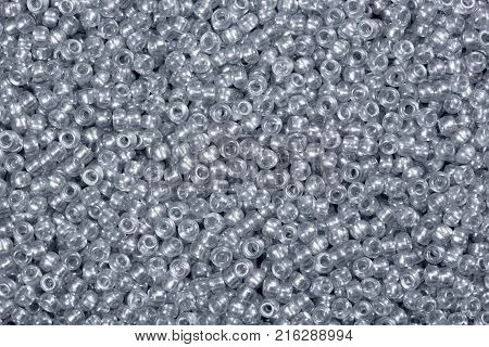 Closeup photograph of multicolored Glass seed beads background. High resolution photo.