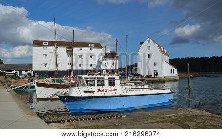 WOODBRIDGE, SUFFOLK, ENGLAND - APRIL 17, 2017: The River Deben at Woodbridge Quay with Tide Mill and Boats.