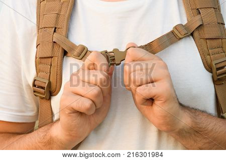 The Young Man Fastens Itself To The Fastex Buckle On The Chest From The Backpack