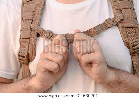 The Young Man Fastens Itself To The Fastex Buckle On The Chest From The Backpack