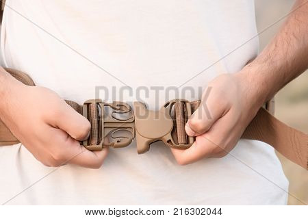 The Young Man Fastens Itself To The Fastex Buckle On The Chest From The Backpack