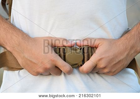 The Young Man Fastens Itself To The Fastex Buckle On The Chest From The Backpack