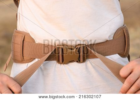 The Young Man Fastens Itself To The Fastex Buckle On The Chest From The Backpack