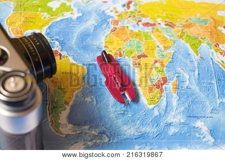 A Photo On Top Of A Journey, A World Map, An Old Camera.