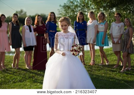Belarus, Brest region, Motol village, August 05, 2017. Wedding Park.The bride throws a bouquet