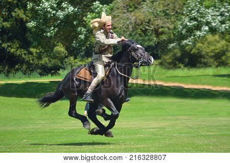 SILSOE, BEDFORDSHIRE, ENGLAND - MAY 28, 2017:  Member of Punjab Lancer  in 
 full galloping  during demonstration of tent pegging.