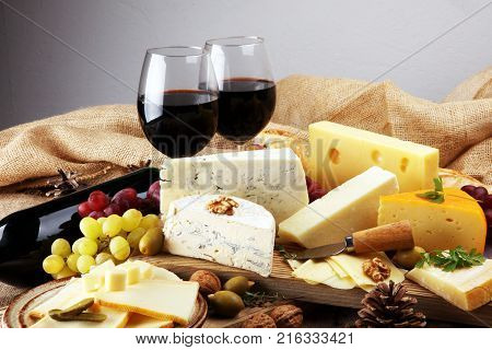various types of cheese on rustic wooden table