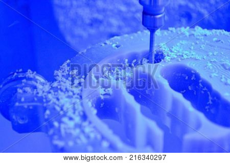 Dental milling machine carving out shape of human teeth close-up