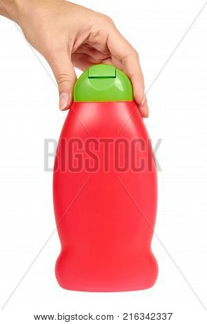 Red plastic bottle for shampoo in hand isolated on white background. Hydiene and cleaning idea.