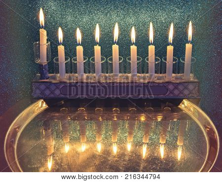 Jewish holiday Hanukkah celebration with menorah and lights of burning candles