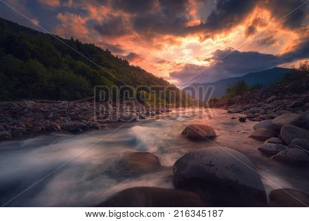 fast mountain river flowing In beautiful sunset time