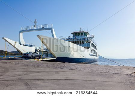 Anchored large ferryboat has opened his front his front entrance for boarding passengers at the local port.