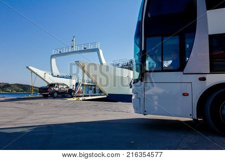 Large ferryboat has opened his front gate for boarding busses and other vehicles at the local port.