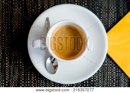 Espresso coffee flay lay in cafe with yellow napkin
