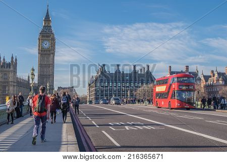 London UK - December 22 2016 : People visit the Big Ben Westminster Bridge and Houses of Parliament near the River Thames in London England.