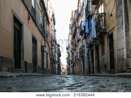 low angle shot of narrow alley in Lisbon Portugal