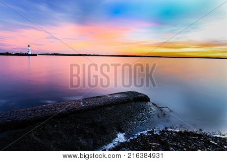 Nightfall overlooking Lac St Louis Lachine Quebec from the walking path with the sun behind the horizon.