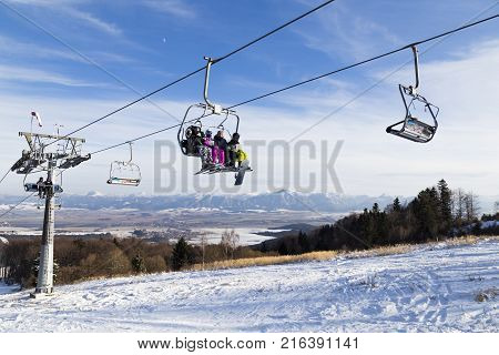 Valcianska Valley snowland. Tatras. Slovakia. 19.01.2016 . Ski resort. Chairlift with skiers on background mountains. Sunny winter day. Winter sport. Concept of leisure active healthy lifestyle winter entertainment