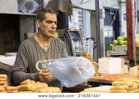 TEL AVIV , ISRAEL - 21 NOVEMBER 2017: Sellers on the old grocery street Nahalat-Benjamin