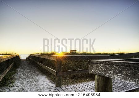 Cocoa Beach Florida with Boardwalk at Sunrise.