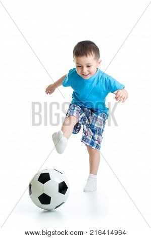 Full length portrait of child boy playing with soccer ball isolated on white background