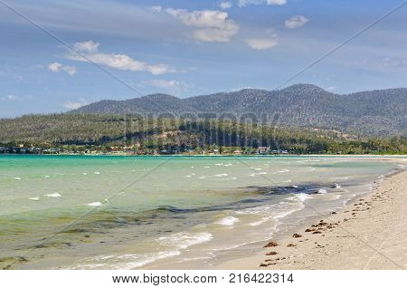 Low refracted swell and wind waves on the iconic Raspins Beach of Orford on the East Coast of Tasmania, Australia
