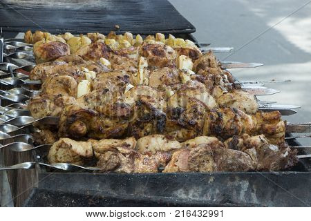 Marinated shashlik preparing on a barbecue grill over charcoal