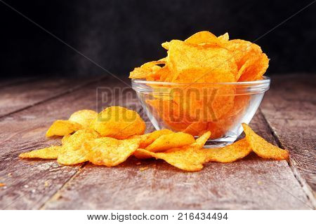 Crispy potato chips in a bowl. Tasty paprika chips.