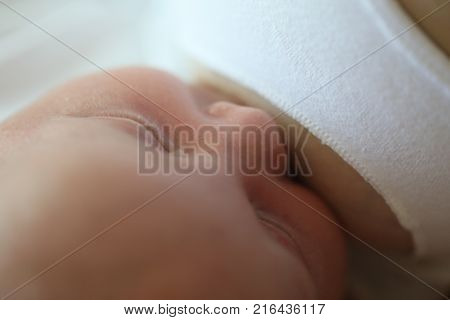 The baby suckles from the mother. Close-up