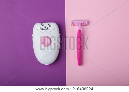 Female epilator and one disposable pink razor, lies on a pink background, free space for text.