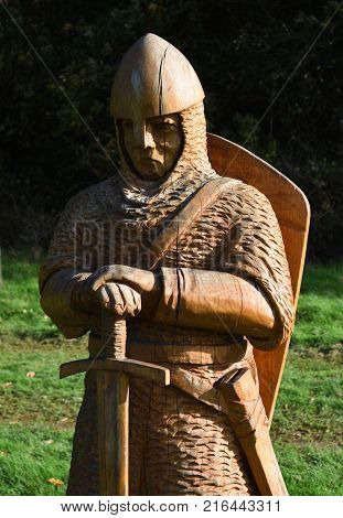 BATTLE, EAST SUSSEX, ENGLAND - OCTOBER 20, 2017: Carved wooden statue of  Battle of Hastings Soldier,
