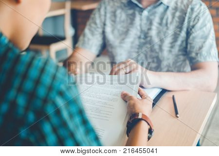 High School Or College Students Studying And Reading Together In Library