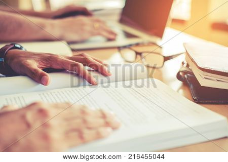 High School Or College Students Studying And Reading Together In Library