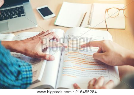 High School Or College Students Studying And Reading Together In Library