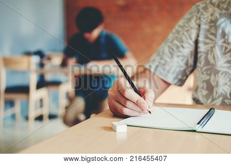High School Or College Students Studying And Reading Together In Library