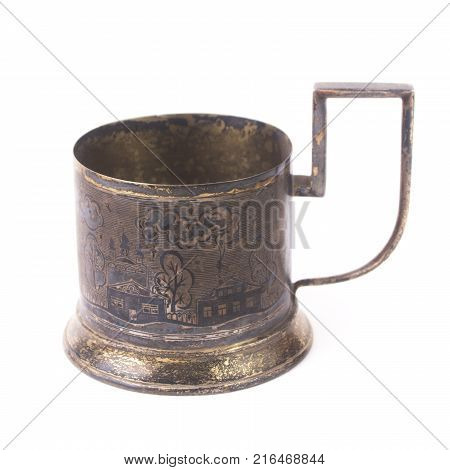 Old silver glass-holder with depicted landscape. Isolated on white background
