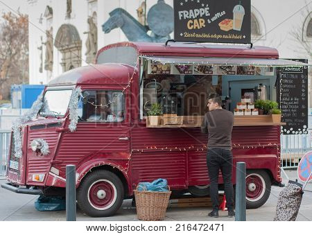 Brno,Czech Republic-November 27,2017: Man is waiting in front of mobile food van at Christmas market at Moravian Square on November 27, 2017 Brno, Czech Republic