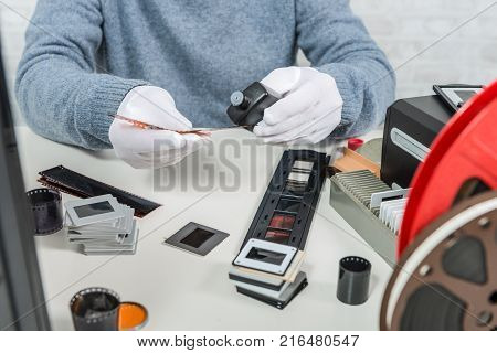 a technician scan a old negative film