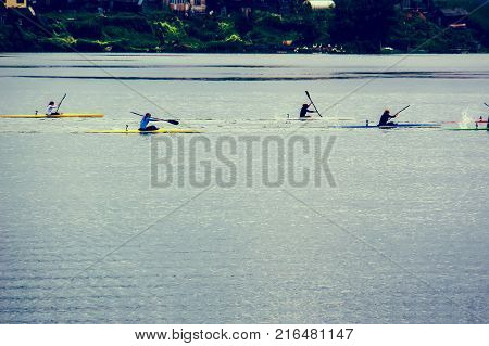 Water sports image people rowing in canoe on river. girls rowing on kayaks on the lake. Rowing competitions in open water among women. Women's sports
