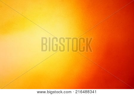 Abstract colorful background with grunge noise grain texture and vivid color gradient of red, orange and yellow