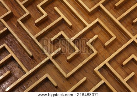 Close up of brown wooden labyrinth maze, toy puzzle game, elevated high angle view