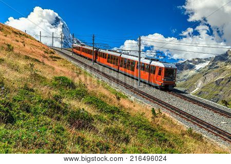Famous electric red tourist train coming down from the Gornergrat station in Zermatt, Valais region, Switzerland, Europe