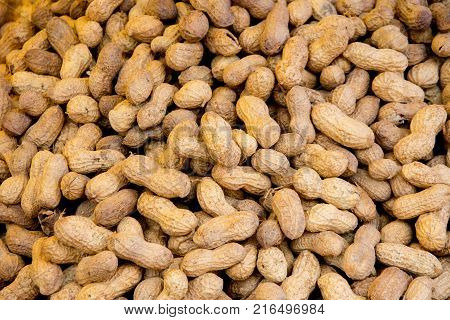 closeup shoot of plie of the unpeeled healthy peanuts