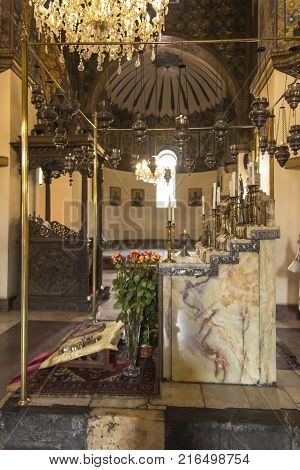 VAGHARSHAPAT ARMENIA - SEPTEMBER 17 2017: Inside one of the oldest Etchmiadzin Cathedrals in the world. It has unique architectural style and design. Altar with chandelier