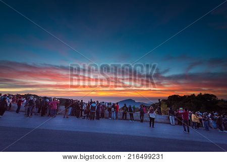 Chiangmai Thailand - November 102017 ; People are watching beautiful sunrise sky and mist green mountain scenery Doi Intanon mountain Thailand.