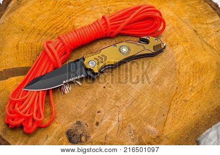 Knife for everyday carrying. Knife with tools for survival. Orange rope.
