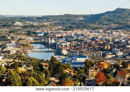 Open view of the historical city of Pontevedra from an elevated viewpoint. Bridges crossing Lerez river during sunset in Autumn.